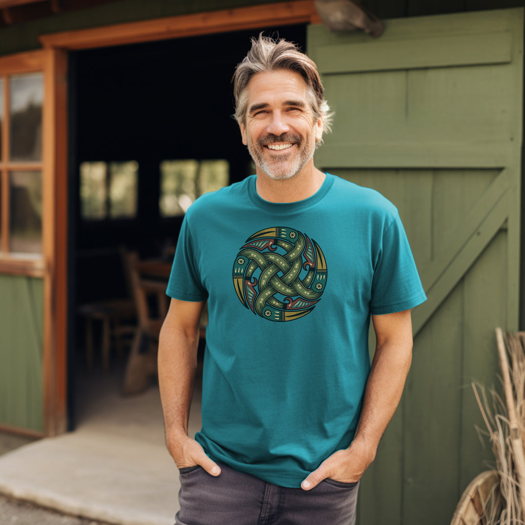 Man outside barn wearing rugged Sapphire Blue T-Shirt with authentic Viking Norse shield design