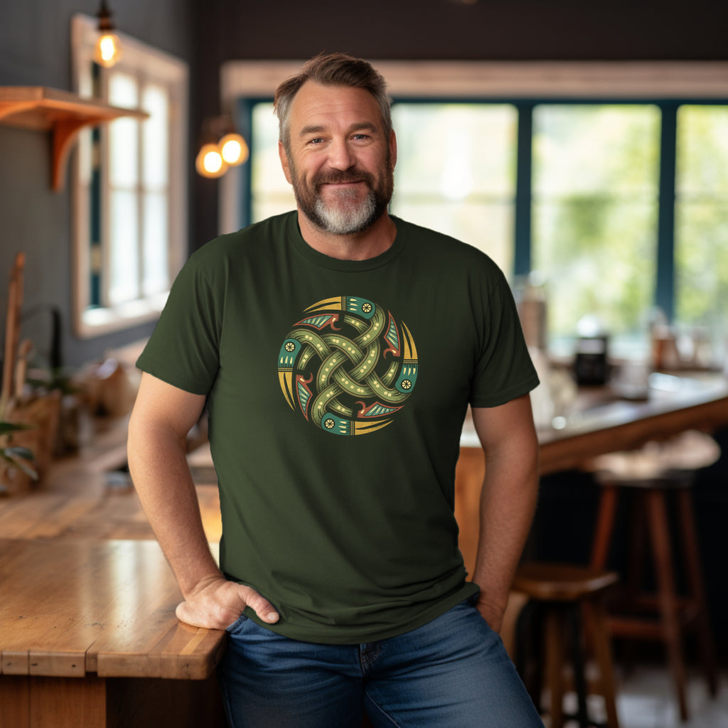 Smiling man wearing rugged hemp green T-Shirt with authentic Viking Norse relic shield design indoors